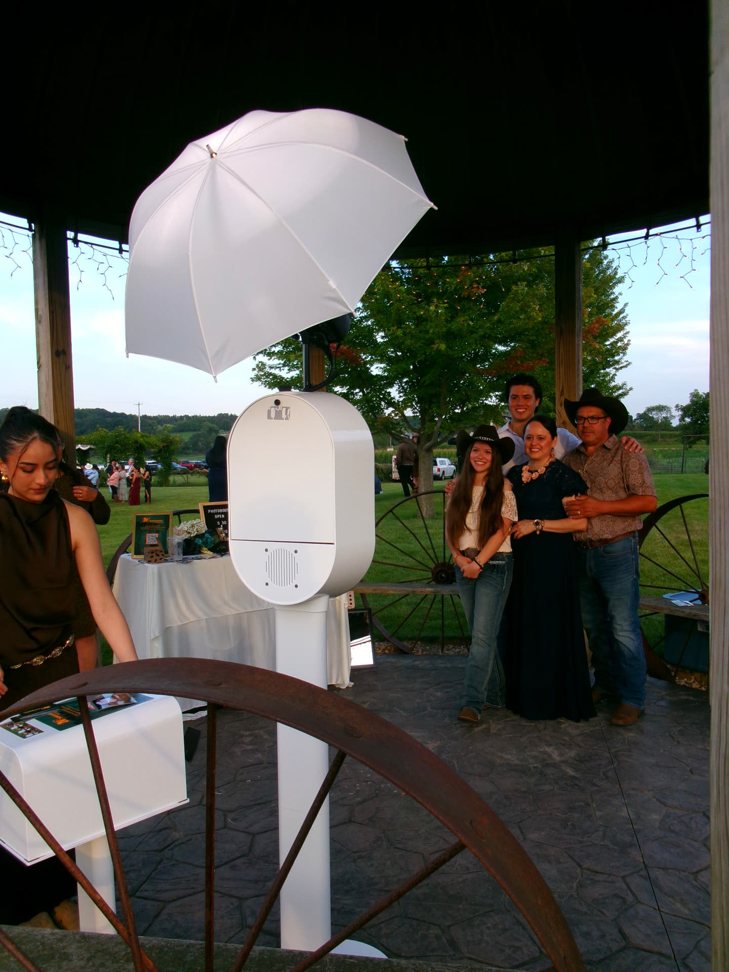 A family posing for the Memento photo booth inside a gazebo at an outdoor Wisconsin wedding