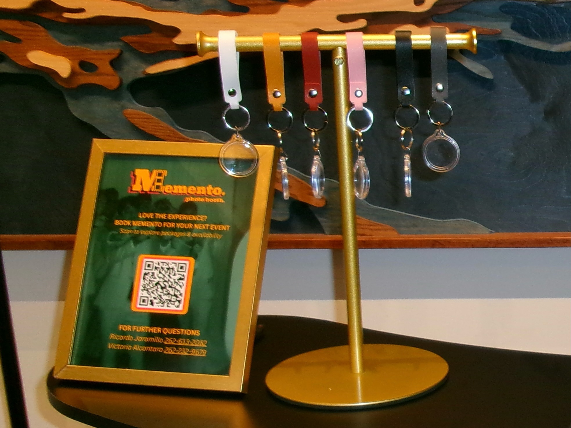 Memento Photo Keychain Station with personalized photo keychains, photo strips, and keychain press at an event